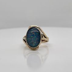 A very fine vintage gold and opal signet style ring.  With oval opal doublet cabochon bezel set in 9ct gold.   Simply a great ring!  Date: 20th Century  Overall Condition: It is in overall good, as-pictured, used estate condition with some very fine & light surface scratches and other signs of expected light wear consistent with age.  Fineness: Marked 9ct for gold fineness.    Marks: 9ct  Measurements: Height: ca. 23 mm Length: ca. 17 mm Width: ca. 19 mm  Weight: ca. 3.5 grams  Ring Size: 6.75 Classic Cabochon Opal Ring, Oval Cabochon Opal Ring With Polished Finish, Classic Oval Opal Ring With Polished Finish, Formal Opal Ring With Polished Finish, Classic Oval Hallmarked Opal Ring, Heirloom Oval Opal Ring For Formal Occasions, Heirloom Oval Cabochon Opal Ring, Classic Cabochon Opal Ring For Formal Occasions, Classic Opal Ring With Polished Oval Cabochon