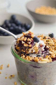 a bowl filled with granola, blueberries and yogurt