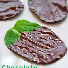 chocolate covered mint leaves on a white plate