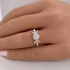 a woman's hand with a diamond ring on it