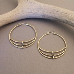 These hand-crafted, brass or sterling silver hoop earrings are modern and simple yet edgy with sweet little Labradorite stones. These are completely crafted by hand.Note: The model photo shows the sterling version for length, fit and size.Made with love in Denver, Colorado- xoMore Details:- Brass with sterling ear wires- Sterling silver with sterling ear wires- Earrings measure 1.75” diameter- 3mm Labradorite stones- These stones vary in color and matrix as all natural stones do- Note: Please re Brass Hoop Earrings With Oxidized Finish, Oxidized Brass Hoop Earrings, Modern Nickel-free Brass Hoop Earrings, Bohemian Hand Forged Hoop Earrings For Everyday, Everyday Bohemian Hand Forged Hoop Earrings, Minimalist Crescent Hoop Earrings, Nickel Free, Modern Crescent Brass Hoop Earrings, Everyday Hand Forged Brass Hoop Earrings, Small Brass Hoop Earrings, Hand Forged