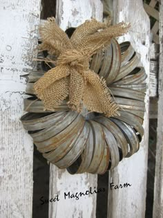 an old door with a wreath hanging from it's side and burlocks