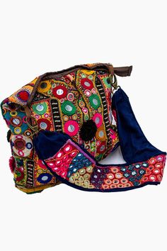 Introducing our Banjara Handbags collection, where tradition meets style. This particular piece is a Banjara Shoulder Bag, a perfect embodiment of Bohemian Chic Accessories. The bag is a riot of colors, featuring a rich tapestry of multicolored fabric. It’s adorned with intricate embroidery and mirror work, adding a touch of sparkle and whimsy. Playful pompoms further enhance its charm, making it a standout piece in any setting. What sets this bag apart is its craftsmanship. As part of our Handc Multicolor Embroidered Hobo Bag For Travel, Embroidered Multicolor Hobo Bag For Travel, Festival Embroidered Multicolor Hobo Bag, Traditional Handmade Multicolor Hobo Bag, Traditional Multicolor Bag With Adjustable Strap, Traditional Multicolor Shoulder Bag For Everyday Use, Multicolor Festival Hobo Shoulder Bag, Multicolor Bags For Daily Use And Festivals, Bohemian Multicolor Travel Satchel