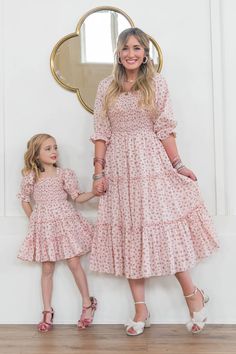 A tried and true Ivy City favorite - The Madeline is back in a brand new pink color! Flowy, feminine, and functional. This carefree tea-length dress is inspired by enchanting beauty, the wind in your hair, and the celebration of being grounded to mother earth. Smocked bodice with puff sleeves and ruffle details. Dreamy pinks and greens and a micro floral print. Also available in matching MINI + BABY sizes! Feminine Pink Tea Length Dress, Pink Tea Length Summer Dress, Pink Tea-length Summer Dress, Pink Feminine Maxi Dress With Smocked Bodice, Pink Fitted Midi Dress, Tea Length, Pink Fitted Tea Length Midi Dress, Pink Smocked Bodice Maxi Dress For Garden Party, Pink Flowy Modest Maxi Dress, Pink Midi Dress With Smocked Bodice