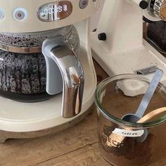 the coffee maker is next to a glass bowl