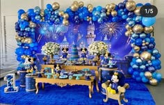 a mickey mouse birthday party with balloons and decorations