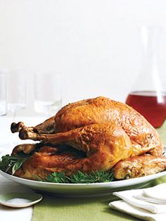 a white plate topped with chicken, potatoes and greens