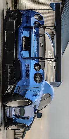 the front end of a blue truck parked in a garage