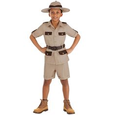 a young boy dressed up in a safari outfit with his hands on his hips and smiling at the camera