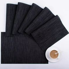 five black napkins and a cup of coffee