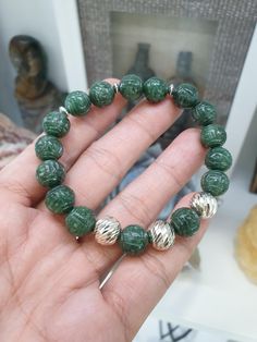 Gift idea 🎁! Deep green Jade beads, 10.5 mm size, engraved with Ruyi swirls to invite  good fortune; Fei Cui, Type A natural Jadeite (non-bleached, non-dyed, non-treated materials) of glossy deep green color, each finely detailed. This Ruyi Bracelet is charmed with 3 pieces of beautifully chiselled Sterling Silver Beads, 10.5 mm size. Bracelet size 17 cm, weighs 36 grams (more or less); may be upsized (to 18 cm) or downsized upon request. To request for resize, you may send us a direct message Adjustable Carved Bracelets With Round Beads, Green Spiritual Bead Bracelet, Green Beaded Bracelets With Large Beads As Gift, Green Spiritual Bracelets With Large Beads, Silver Jade Bracelet With 8mm Beads, Green Carved Bracelet As A Gift, Green Stretch Bracelet With Round Beads In Spiritual Style, Green Carved Bracelets As Gift, Traditional Green Beaded Bracelets With 8mm Beads