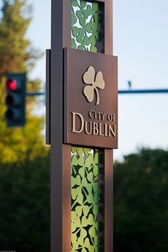 a sign for the city of dublin in front of some trees