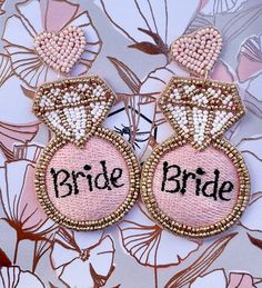 These fun earrings are the perfect accessory for you and your Bride Team! They are crafted with seed beads and feature a heart-shaped post. Gift wrap and personalized card are available! Pink Beaded Drop Earrings For Wedding, Handmade Pink Beaded Earrings For Wedding, Embellished Dangle Beaded Earrings For Party, Valentine's Day Wedding Beaded Jewelry, Beaded Dangle Earrings For Wedding, Beaded Dangle Bridal Earrings For Wedding, Wedding Embellished Jewelry With Round Beads, Bridal Beaded Dangle Earrings For Wedding, Valentine's Day Gold Beaded Earrings For Party