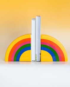 ceramic rainbow shaped bookends with books in the center Clay Bookends, Rainbow Bookends, Ceramic Book Ends, Ceramic Bookends, Ceramic Book, Ceramic Rainbow, Rainbow Decor, Rainbow Order, Reading Rainbow