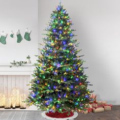 a brightly lit christmas tree in a living room