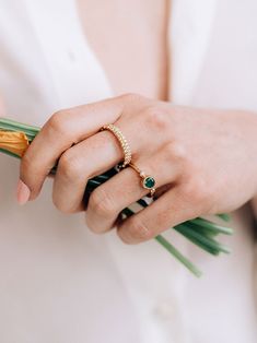 A round Emerald is delicately bezel set in a gold hammered band, along with a bezel set diamond and gold Dew Drop detail.This dainty everyday ring can be worn as a stackable set or on its own. Size: 7 Emerald Gemstone measures 5mm Diamond carat weight 0.03 14k yellow Gold Looking for a different ring size? Contact us at hello@meusshop.com Designed by Anzie Elegant Everyday Stackable Rings With Bezel Setting, Everyday Diamond Ring With Bezel Setting, Fine Jewelry Stackable Rings With Bezel Setting, Stackable Rings With Rose Cut Diamonds, Elegant Emerald Ring With Bezel Setting, Everyday Bezel Setting Birthstone Ring, Fine Jewelry Stackable Emerald Ring, Fine Jewelry Stackable Emerald Ring With Round Band, Stackable Emerald Ring With Round Band