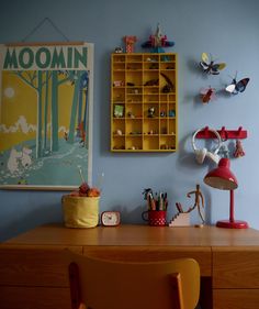 a room with a desk, chair and poster on the wall