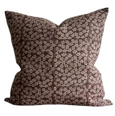 a brown and white pillow on a white background