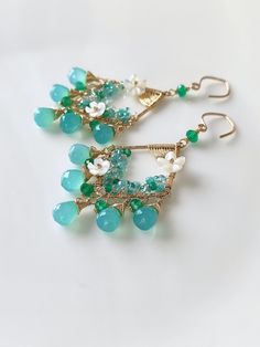 This romantic pair of earrings is composed of blue chalcedony and green onyx, embellished with some white mother of pearl flowers, turquoise, apatite, and some seed beads. The overall look is very refreshing and romantic. ●blue chalcedony ●onyx ●turquoise ●apatite ●mother of pearl flowers ●seed beads ●14k gold filled ● total length approximately: 2.67 inches ● weight：5.2g Welcome to visit my Jewelry store: https://www.etsy.com/shop/Ukuly 🌸The delivery time to Most regions of North America, Australia and Europe is usually about 10-15 days. Buyers from Brazil, South Korea, and Indonesia, please provide me with your tax number through messages or notes for smooth shipment. Thank you. 🌸Please let me know your phone number when you place an order. It will be used for shipping label only. 🌸I Elegant Handmade Turquoise Chandelier Earrings, Briolette Gemstone Chandelier Earrings As Gift, Blue Gemstone Chandelier Earrings For Gifts, Handmade Turquoise Chandelier Earrings, Handmade Turquoise Briolette Earrings, Gemstone Chandelier Earrings As Gift, Handmade Teardrop Chandelier Earrings For Anniversary, Unique Earrings Gold, Romantic Blue