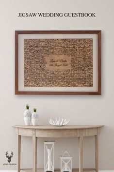 a wooden table with two vases on it and a framed wedding guest book in the background