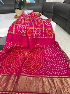 Beautiful Silk Saree with Bandhani print . Suitable for every occasion.  Saree Material ------Art Silk  Color ---------Rani bright pink  Saree length -------5.50 m  Blouse --------unstitched  Blouse meters --------0.9 m  Work of sareee------  Bandhani print with Zari Pallu n Gota Border.  🥰 Fall and piko already done .  🥰 Ready to wear .  🥰 Dry clean wash as it is Handmade Bandhani saree ( Original) , not machine printed.  Occasions: Wedding Wear, Party Wear, Festive Wear, Durga Puja, Indian Bandhani Print, Bandhani Saree, Durga Puja, Zari Work, Pink Saree, Wedding Wear, Indian Wear, Festival Wear, Bridal Wear