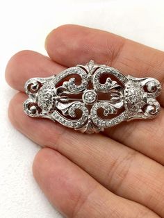 Very beautiful art deco 14k solid white gold natural diamond pin brooch. (( Can be modified to pendant.)) Weight: 10.6 grams Size appx: 44*25 mm Total diamond weight:1.19 Ct Center stone size: 3.3 mm, 0.15 Ct Diamond clarity and color: SI1-2/ G Mounted diamonds are calculated by measurements and might be different more or less. Please add me to your Favorites list Classic White Gold Brooch With Brilliant Cut, Classic Diamond Brooch In White Gold, Classic White Gold Diamond Brooches, Classic Diamond White Diamond Brooch, Classic White Gold Diamond Brooch, Art Deco Diamond Brooches As Gifts, Luxury Silver Brilliant Cut Brooches, Art Deco Diamond Brooches For Gifts, Art Deco White Gold Brooch In Platinum