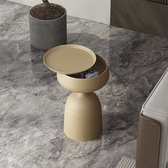 a marble counter top with two vases and a planter on the table next to it