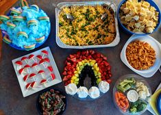 a table topped with lots of different types of foods and desserts next to each other