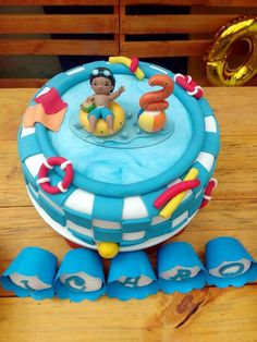 a birthday cake with blue icing and decorations