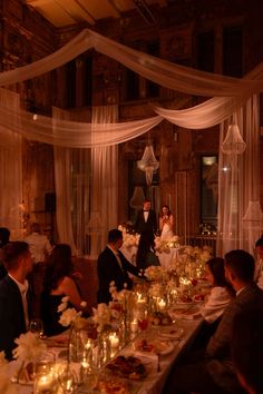 a group of people sitting around a long table