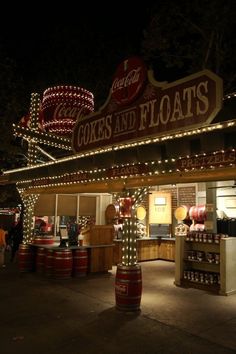 the exterior of a store with lights on it