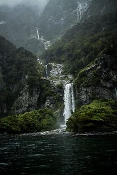 a waterfall in the middle of some mountains