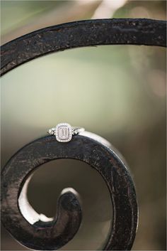 a diamond ring sitting on top of an iron fence