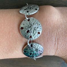 Great For Summer! Handmade In The Usa. New, But No Literal Tags Attached. Each Sand Dollar Charm Is Silver-Plated. Bracelet Measures Default 7.” Lobster Clasp. Jazz Up Any Outfit With This Great Piece! Check Out My Other Handmade Listings, Including Matching Earrings! Thank You! #Beach #Sand #Bracelet Casual Silver Bracelets For Beach, Nickel-free Bracelets For Beach, Adjustable Metal Bracelet For Vacation, Adjustable Metal Bracelets For Vacation, Casual Metal Jewelry For Beach, Hand Crafted Jewelry, Sand Dollar, Crafted Jewelry, Beach Sand