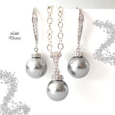 "The listing is for the Earrings AND Necklace set shown in the first picture. Timeless and classic Pearl Earrings and Necklace set made with: - lustrous 10mm round Light Grey pearls (NOT cheap glass pearls) - Hypoallergenic Rhodium plated rhinestone ear hooks - rhodium plated and tarnish resistant beautiful Cubic Zirconia/CZ embellished bail and sparkly connectors - the earrings are about 1 1/4\" from top of the ear wires to bottom of the pearls - The pendant drop is 7/8\" (23mm) Finished with a Cheap Classic Pearl Drop Earrings, Cheap Adjustable Everyday Bracelets, Pearl Earrings And Necklace, Handmade Pearl Jewelry, Classic Pearl Earrings, Bridal Bracelet Pearl, Grey Pearl Earrings, White Pearl Jewelry, Earrings And Necklace Set