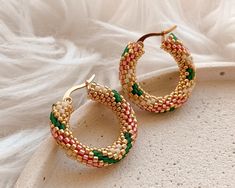 💖 Add a pop of color to your everyday look with these double sided beaded hoop earrings! Handmade with care, these unique seed bead hoop earrings feature a beautiful geometric pattern in gold, beige, pink, and deep green for a playful and eye-catching look. These earrings make the perfect birthday gift for mom or anyone who loves one-of-a-kind accessories Stand out from the crowd with these statement earrings that are sure to become a staple in your jewelry collection! These huggie hoops earrin Pink Hoop Earrings With Tiny Beads As Gift, Pink Hoop Earrings With Tiny Beads For Gift, Trendy Colorful Beaded Hoop Earrings For Gifts, Pink Small Hoop Beaded Earrings As Gift, Trendy Handmade Hoop Beaded Earrings, Trendy Hoop Beaded Earrings As Gift, Hoop Earrings With Spacer Beads As Gift, Hoop Earrings With Spacer Beads For Gifts, Handmade Beaded Hoop Earrings Gift