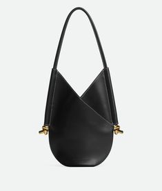 "Find BOTTEGA VENETA Small Solstice on Editorialist. Small calf leather shoulder bag. Single detachable interior zipped pocket. Leather string closure. Lining: Suede. Color: Black. Hardware: Brass finish. Height: 30 cm | 11.8\". Width: 26 cm | 10.2\". Depth: 2 cm | 2.6\". Handle drop: 26 cm | 10.2\". Calfskin." Bottega Bag, Smaller Calves, Whats In Your Purse, All Black Fashion, Small Shoulder Bags, Canvas Shoulder Bag, Black Hardware, White Bag, Brass Finish