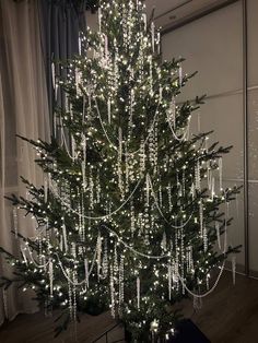 a christmas tree with white lights in a room