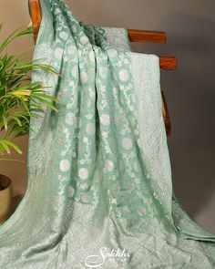 The Sea-Green Banarasi georgette saree drapes like a whisper of elegance, its intricate silver zari  weaving tales of ancient splendor. Each fold captures the essence of Varanasi's timeless artistry, shimmering with a delicate allure. A symphony of tradition and modernity, it wraps the wearer in a legacy of grace and beauty. Paired with a gorgeous tonal elbow sleeved stitched blouse. Transitional Green Saree With Sheer Dupatta, Green Georgette Pre-draped Saree For Transitional Season, Green Chikankari Embroidery Pre-draped Saree In Georgette, Green Georgette Pre-draped Saree With Chikankari Embroidery, Green Georgette Traditional Wear For Transitional Season, Green Chikankari Embroidery Pre-draped Saree For Diwali, Elegant Green Pre-draped Saree With Chikankari Embroidery, Silver Georgette Dupatta In Traditional Drape, Green Saree With Chikankari Embroidery For Transitional Season