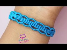 a blue bracelet with an intricate design on the wrist, and a small knot in the middle