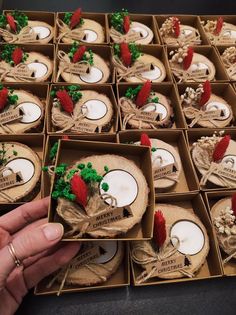 a box filled with lots of wooden slices covered in red and green decorations on top of a table