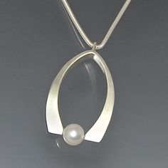 Petal Pearl Pendant by Susan Panciera: Silver & Pearl Necklace available at www.artfulhome.com Modern Pearl Charm Jewelry For Anniversary, Modern Akoya Pearl Jewelry With Pearl Charm, Modern Pearl White Jewelry With Pearl Drop, Modern Pearl Pendant Jewelry For Anniversary, Modern Sterling Silver Jewelry With Pearl Pendant, Modern Akoya Pearl Jewelry For Formal Occasions, Akoya Pearl Oval Pendant Jewelry, Oval Akoya Pearl Pendant Jewelry, Unique Pearl Drop Jewelry For Formal Occasions