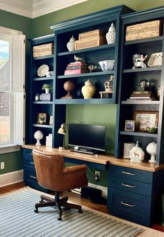 a home office with built in bookshelves and desk