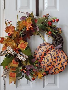 a leopard print pumpkin wreath on the front door