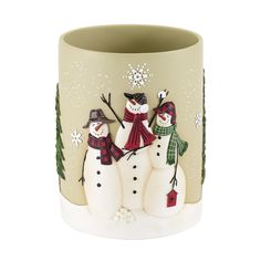 two snowmen are standing next to each other in front of a vase with frosting on it