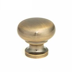 an antique brass cabinet knob on a white background