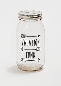 a glass jar with the words vacation fund written on it and an arrow in front