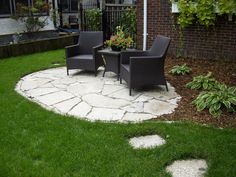 two chairs sitting on top of a stone patio