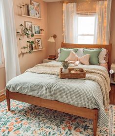 a bed room with a neatly made bed and a tray of food on top of it