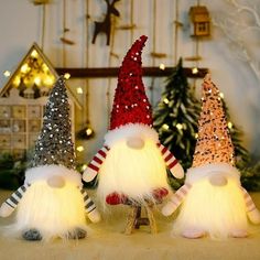 three christmas gnomes with lights on their heads